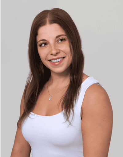 Experienced female professional with long brown hair smiling, representing Gresham House's investment and asset management services, emphasizing expertise in sustainable investments and portfolio management.