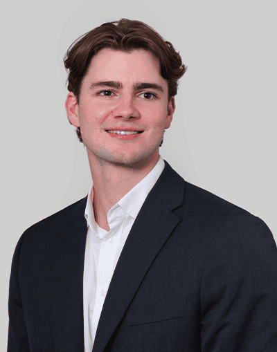 Professional businessman in formal suit representing Gresham House investment and asset management services.