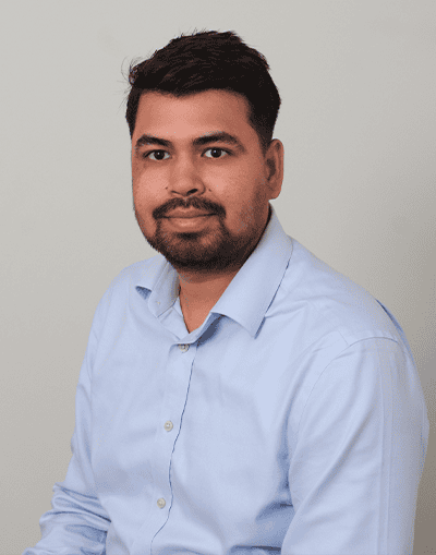 Professional male in a light blue shirt, portrait for Gresham House corporate website.