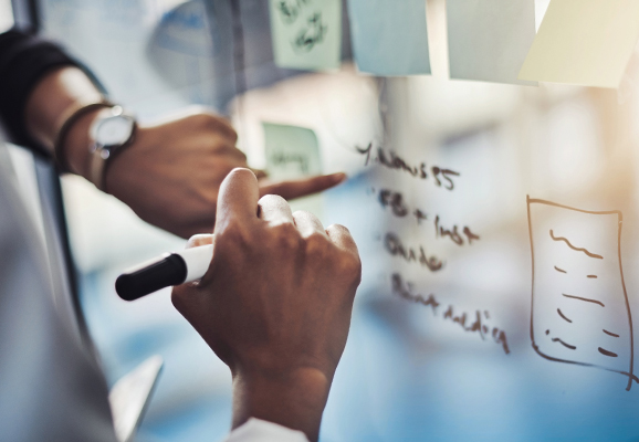 People writing on the board table