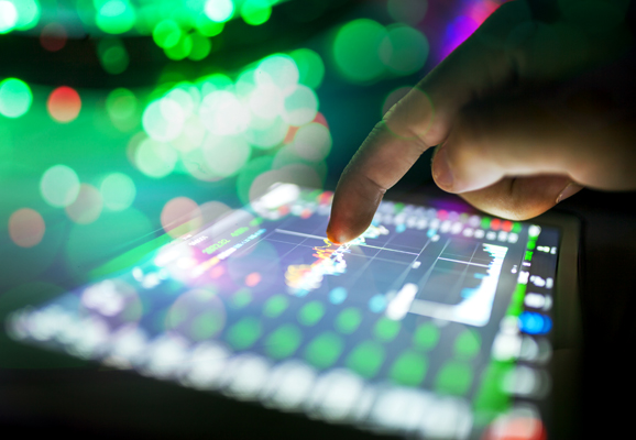 Man typing on a tablet by night