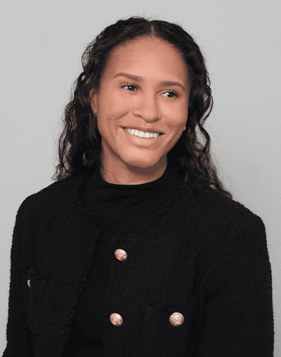 Elegant woman in business attire representing Gresham House investment management services, smiling confidently, emphasizing professionalism and trustworthiness in sustainable asset management.