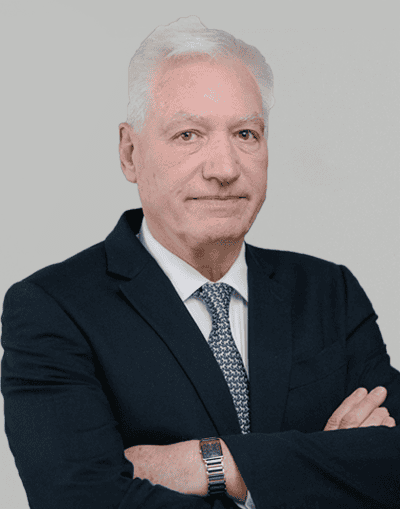 Professional businessman in formal suit with crossed arms showcasing confidence at Gresham House, a leading investment management firm in the UK.