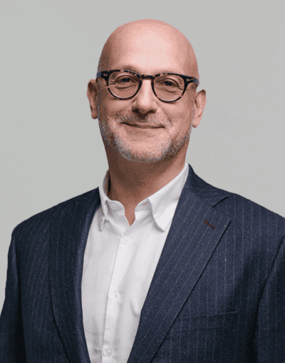 Experienced financial professional in a navy pinstripe suit, representing Gresham House with expertise in investment management and sustainable asset classes.