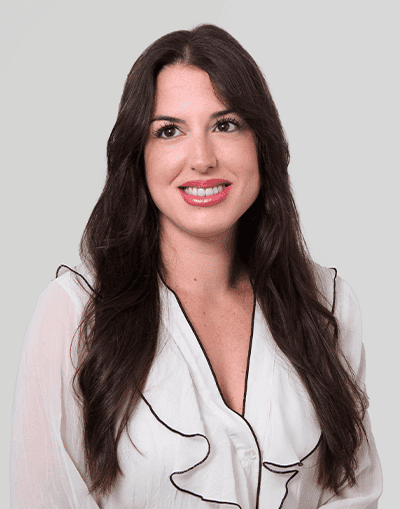 High-quality image of a smiling professional woman representing Gresham House, an established asset management firm in the UK, showcasing expertise in sustainable investing and alternative assets.