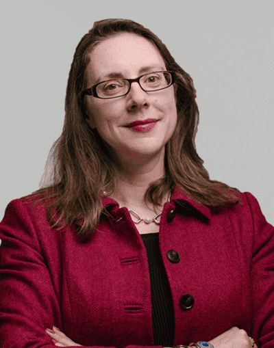 Experienced professional woman in business attire representing Gresham House investment firm.